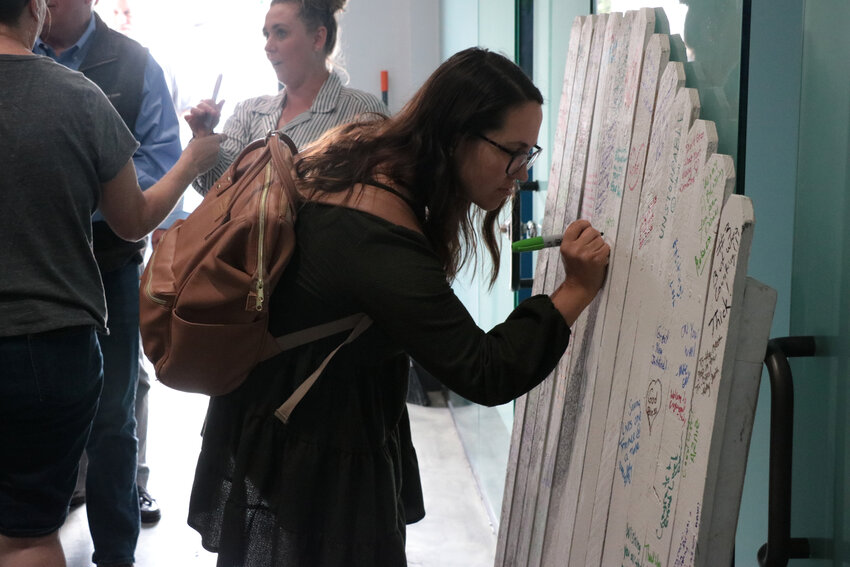 Attendees of the groundbreaking ceremony wrote messages of encouragement on a fence that was found in the original building. After renovations, the artifact will be on display to encourage and inspire trainees.